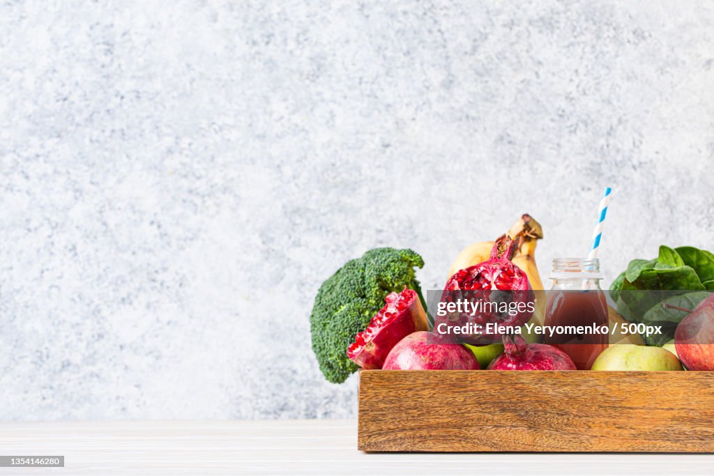 Close-up of fruits and vegetables on table against white background