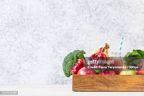 Closeup Of Fruits And Vegetables On Table Against White Background High-Res Stock Photo