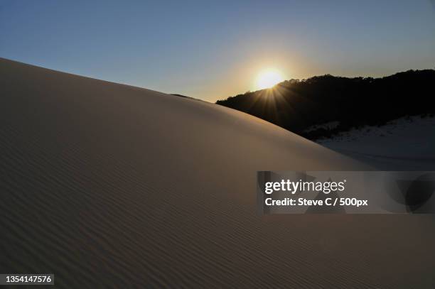 scenic view of desert against clear sky during sunset,moreton island,queensland,australia - moreton island stockfoto's en -beelden