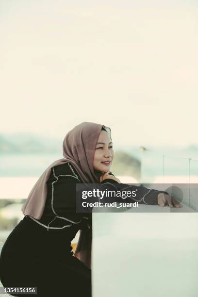 asian hijab woman enjoy  travel in labuan bajo - muslim woman beach stock pictures, royalty-free photos & images