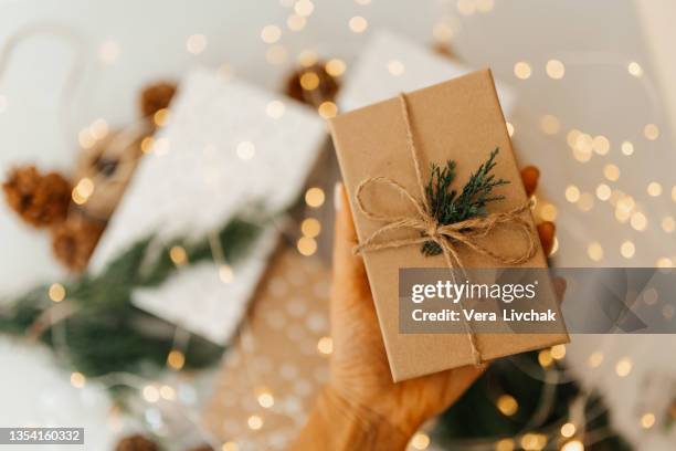 woman wrapping christmas presents in a crafty way - home made gift stock pictures, royalty-free photos & images