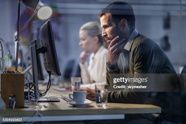 profile view of a pensive programmer reading codes on a pc in the office. - staring at screen stock pictures, royalty-free photos & images