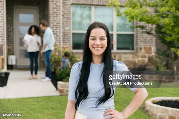 portrait of confident young adult female real estate agent - real people family portraits stockfoto's en -beelden