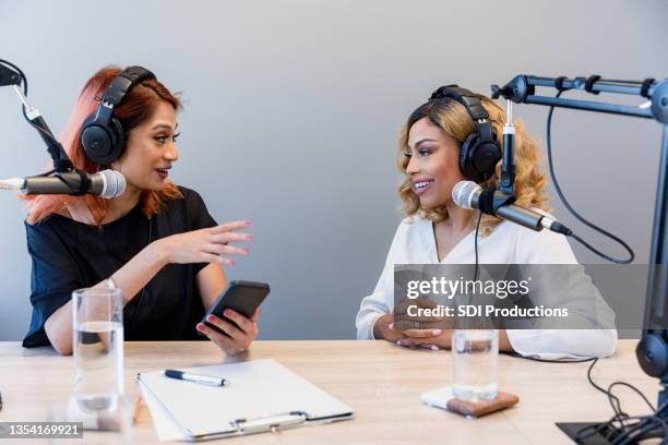 mid adult woman interviews female guest for radio show - studio interview stockfoto's en -beelden