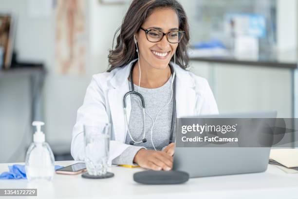 female doctor on a telehealth call - telehealth visit stock pictures, royalty-free photos & images