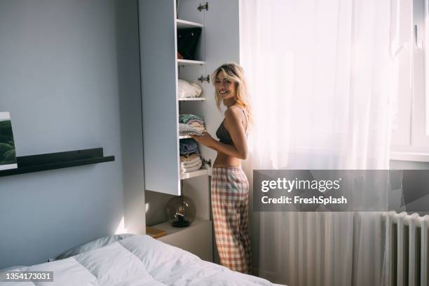 a beautiful young female getting dressed - hotel closet stock pictures, royalty-free photos & images