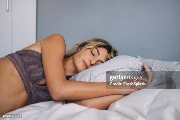 a blonde woman sleeping peacefully - beha stockfoto's en -beelden