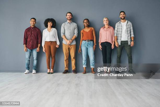 full length portrait of a young and diverse group of businesspeople standing against a grey background in studio - people white background stock pictures, royalty-free photos & images
