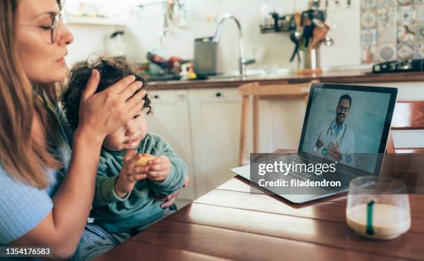 telemedicine - mother and baby and laptop stock pictures, royalty-free photos & images