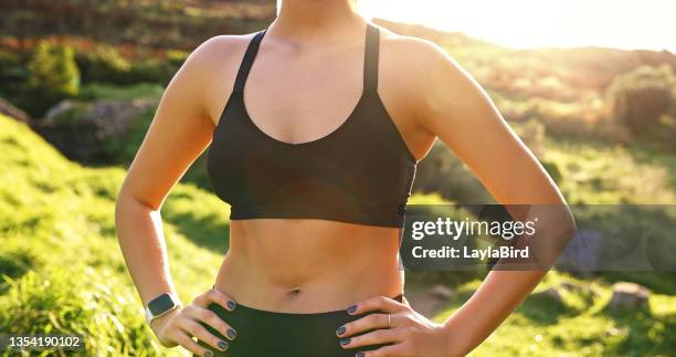 shot of a woman taking a break during her morning run - woman's chest stock pictures, royalty-free photos & images