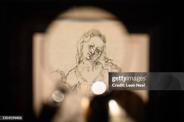 Pen and black ink drawing by Albrecht Dürer titled "The Virgin and Child with a Flower on a grassy Bench" is seen during a photo call at London Art...