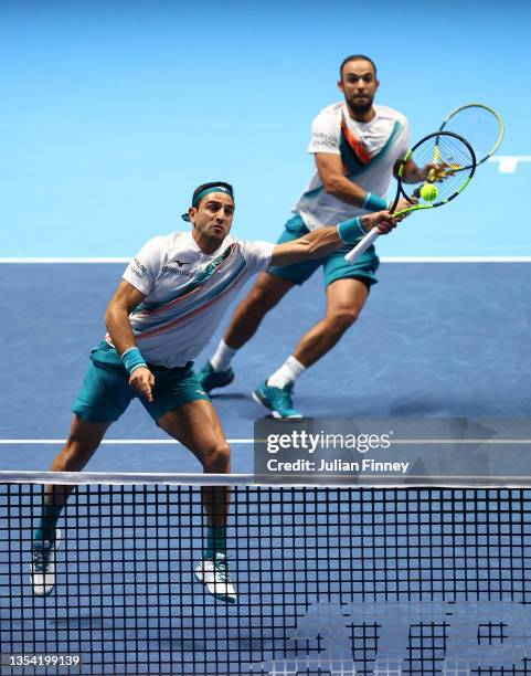 Robert Farah of Colombia volleys as partner Juan Sebastián Cabal of Colombia looks on during the Round Robin match against Joe Salisbury of Great...