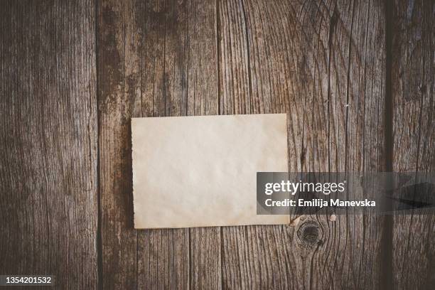 recycled paper on an old wooden desk - wood table top stock-fotos und bilder