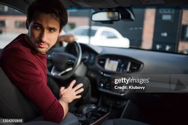 young man driving a car - reverse stock pictures, royalty-free photos & images