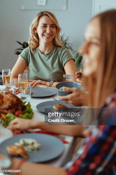 friends and family celebrating new year and eating dinner - champagne brunch stock pictures, royalty-free photos & images