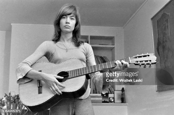 French singer, songwriter and actress Francoise Hardy holds a acoustic guitar as she poses at her apartment in Paris, September 1973.