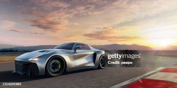 silver roadster sports car moving at high speed along racetrack at dawn - bmw sports car stock pictures, royalty-free photos & images