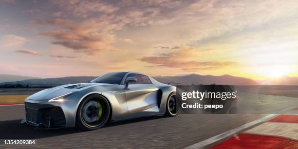 silver roadster sports car moving at high speed along racetrack at dawn - sports car stock pictures, royalty-free photos & images