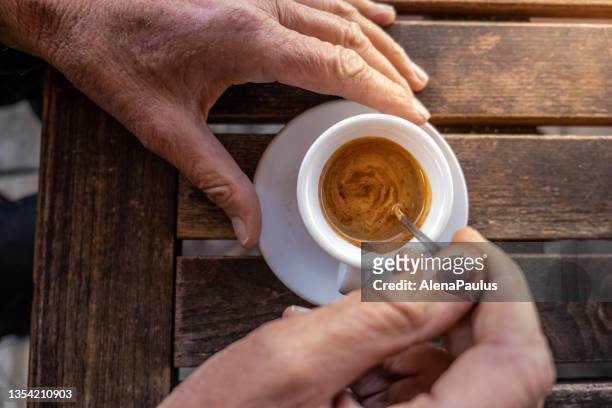 senior man drinking his morning coffee - espresso stockfoto's en -beelden