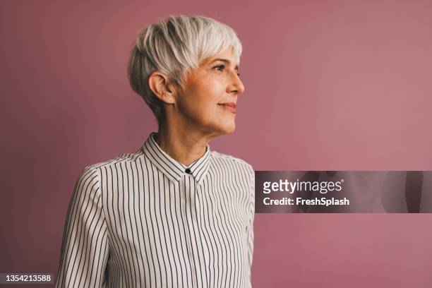 portrait of a senior business woman - woman studio shot stock pictures, royalty-free photos & images