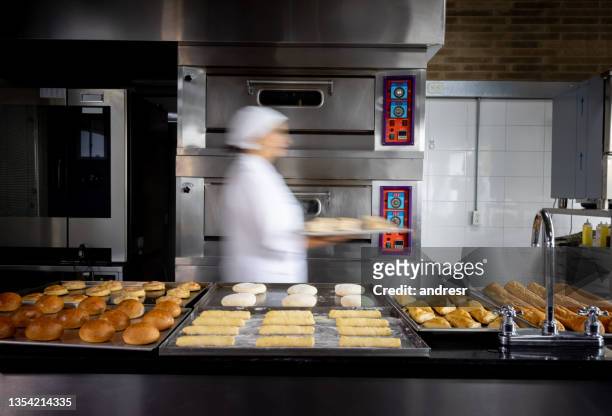 baker on the move baking bread during rush hour - kneading stock pictures, royalty-free photos & images