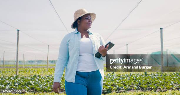 shot of a young woman using a digital tablet while working on a farm - farm woman 個照片及圖片檔