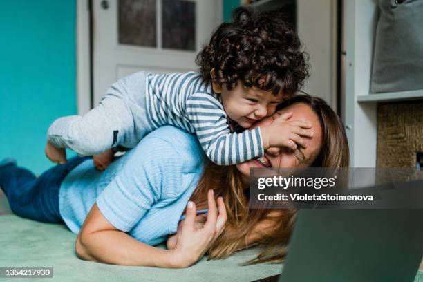 mother and baby working at home. - workplace relations stock pictures, royalty-free photos & images