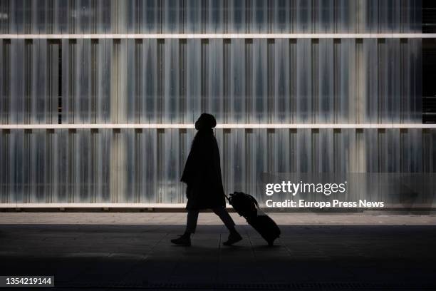 Woman walks with her luggage at Barcelona-El Prat Airport on November 19 in El Prat de Llobregat, Barcelona, Catalonia, Spain. 39 passengers with...