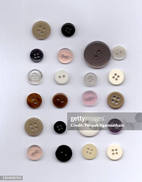 group sewing button circle shape four hole many color isolated on white background - button sewing item stock-fotos und bilder