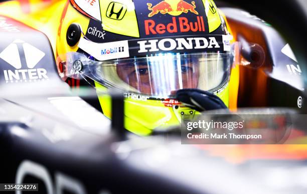 Sergio Perez of Mexico and Red Bull Racing prepares to drive in the garage during practice ahead of the F1 Grand Prix of Qatar at Losail...