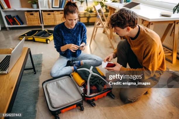 we are getting ready to travel - suitcase couple stockfoto's en -beelden