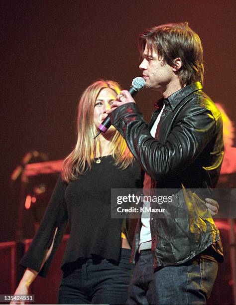 Jennifer Aniston and Brad Pitt show off Jennifer's engagement ring onstage at the Beacon Theater during a Sting concert on Nov. 21, 1999.