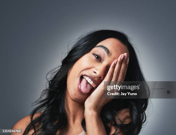 shot of a beautiful young woman posing against a grey background - hands covering eyes stock pictures, royalty-free photos & images