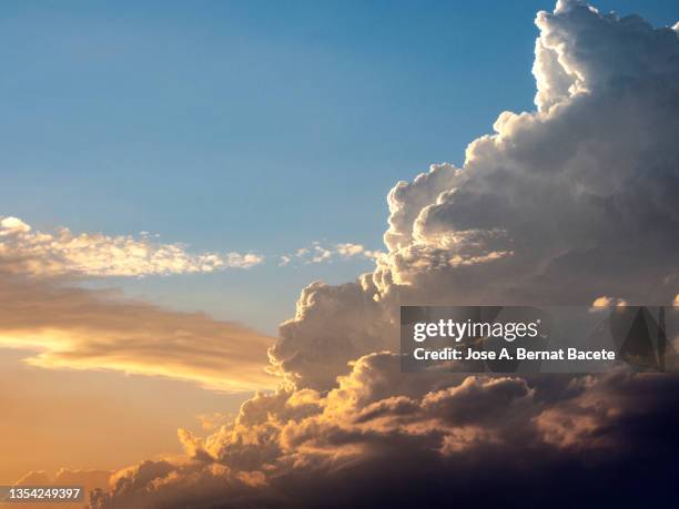 full frame of storm clouds and rain in the sky during a sunset. - grey clouds stock pictures, royalty-free photos & images