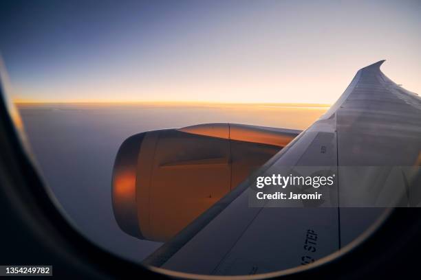 view through airplane window at beautiful sunset - airplane part fotografías e imágenes de stock
