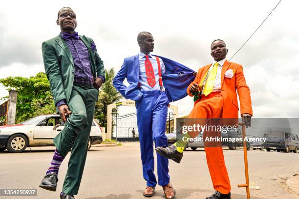 Congolese followers of the Sape showing off in a street in Libreville, April 23, 2014.