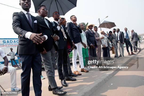 Congolese 'sappers' followers of the Society of Ambianceurs and Elegant People during a public parade in a street of their stronghold in the Bas...