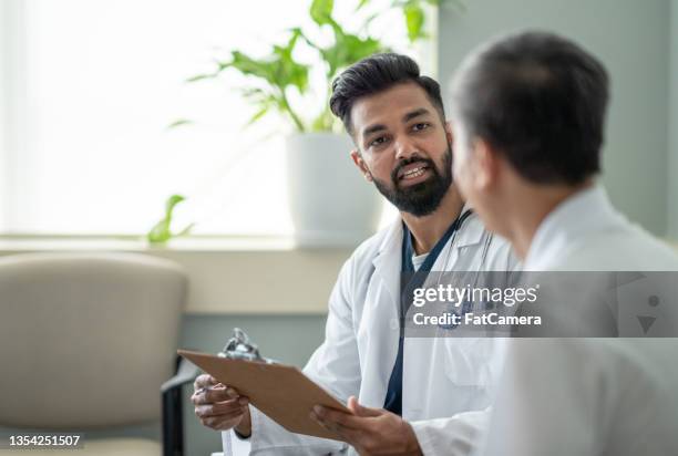 obtaining a medical history - 50 year old male patient stock pictures, royalty-free photos & images