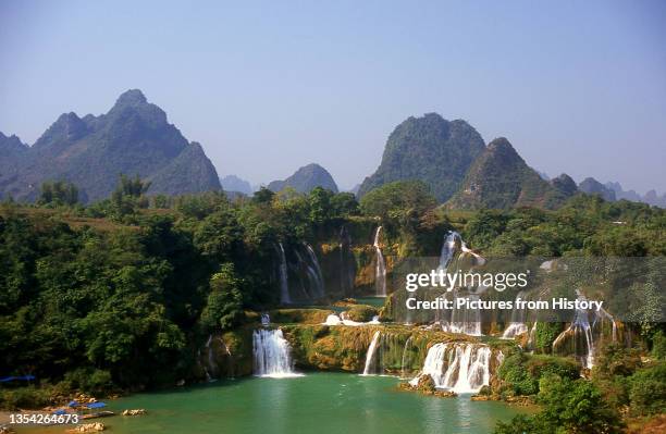 Ban Gioc Detian Falls are 2 waterfalls on the Quay Son River or Guichun River straddling the Sino-Vietnamese border, located in the Karst hills of...