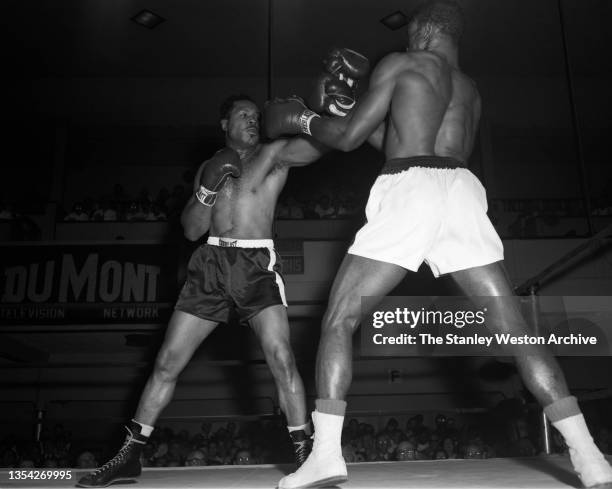 Photo shows action between Archie Moore and Bert Whitehurst . Archie Moore would win the fight by TKO, in the 6th round at St. Nicholas Arena, New...