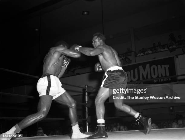 Photo shows action between Archie Moore and Bert Whitehurst . Archie Moore would win the fight by TKO, in the 6th round at St. Nicholas Arena, New...