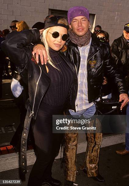 Bret Michaels of Poison and Pamela Anderson pose for a photo at Love Ride 11 to benefit muscular dystrophy on November 13, 1994 in Glendale,...