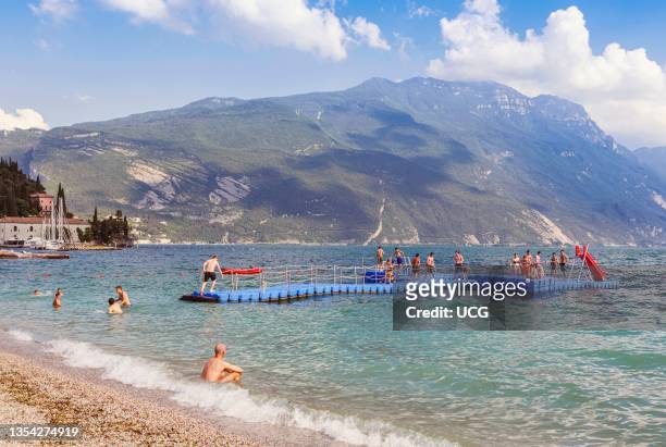 Riva del Garda, Trentino Province, Italy. Lake Garda. Lago di Garda. Bathers enjoying the waters.