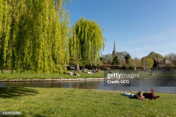 Salisbury, Wiltshire, England, UK, People enjoying the Queen Elisabeth Gardens overlooking the River Avon close to the city center.