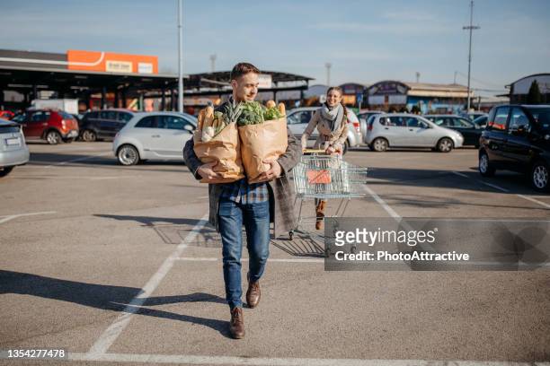 let's go shopping together - carrying bags stock pictures, royalty-free photos & images