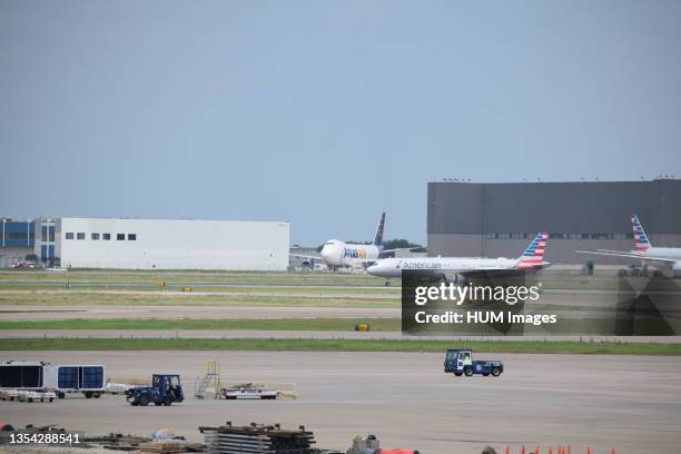 Dallas-Ft. Worth Airport: American Airlines jet after landing at DFW Airport; a cargo jet from Atlas Air in the background.