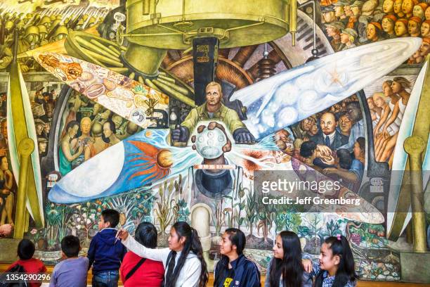 Mexico, Mexico City, Palace of Fine Arts, Art Deco mural by Diego Rivera, Man at the Crossroads, with students taking selfies.