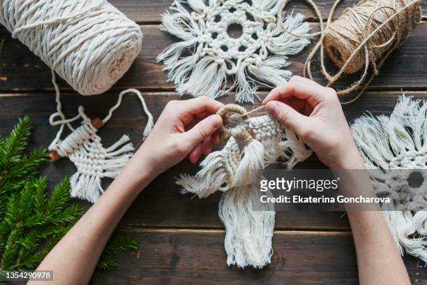 children's hands and crafts made of white cotton threads in the macrame style. - macrame stock pictures, royalty-free photos & images