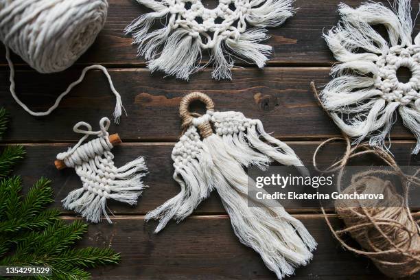 crafts made of white cotton threads in the macrame style. handmade christmas tree decorations. - macrame stock-fotos und bilder