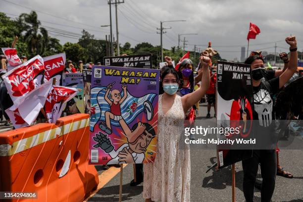 Protesters wearing protective gear march ahead of President Rodrigo Duterte's last state of the nation address in Quezon City, Metro Manila....